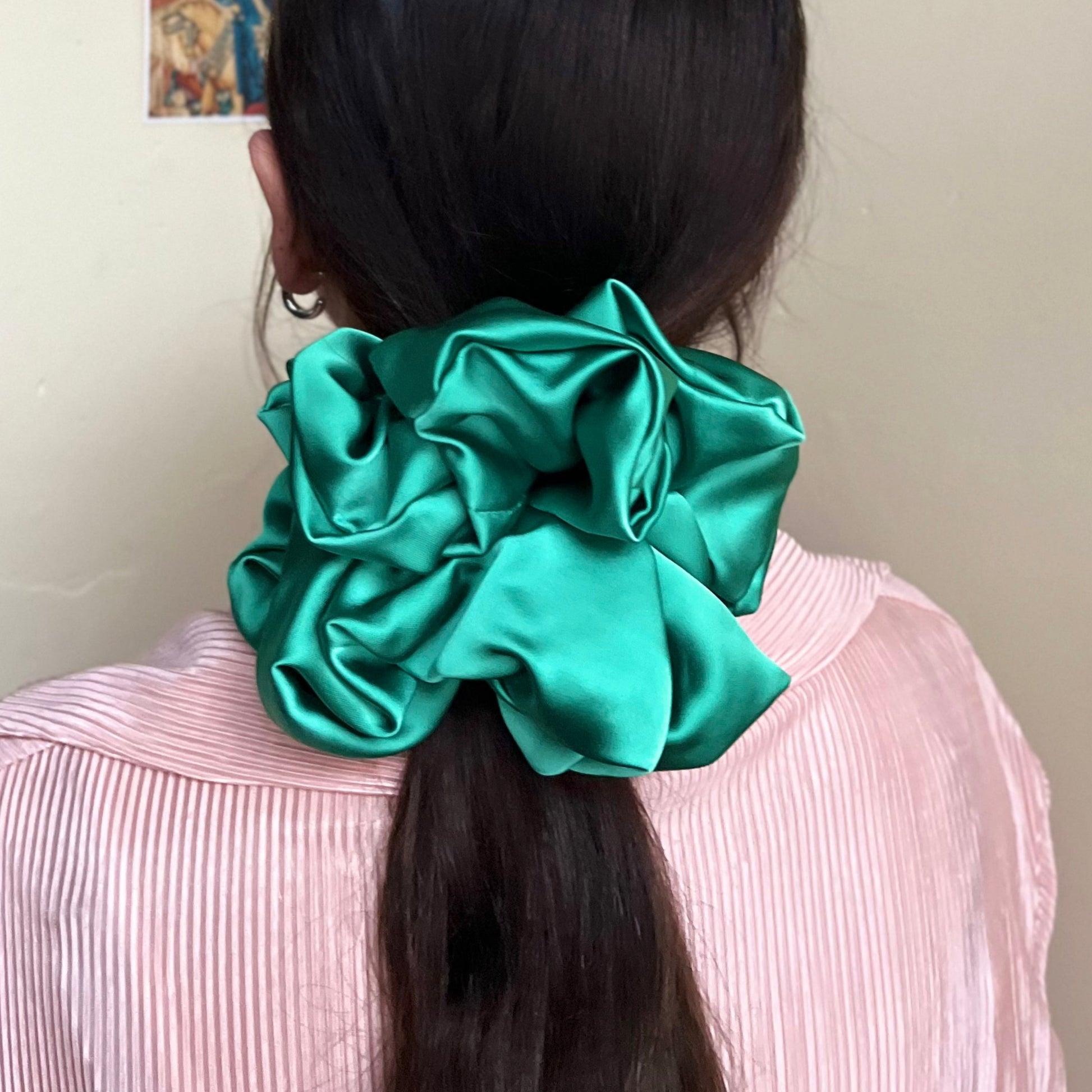 oversized silky premium satin scrunchie with extra hold in lush green adorns pony tail. handmade in nottingham for all hair types.