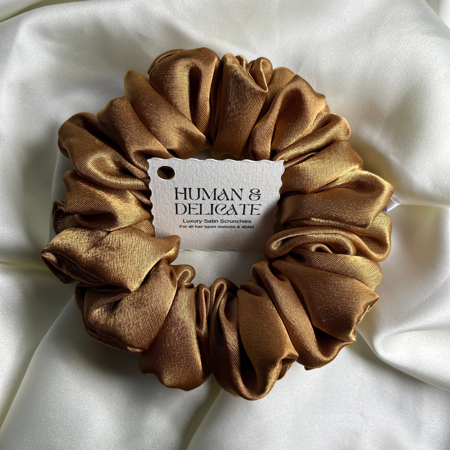 Soft silki mini petite scrunchie made with antique gold high quality luxury satin. Perfect for all hair thicknesses types and textures. Handmade in nottingham with slow and low-waste processes