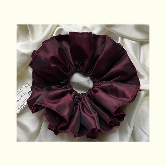 Bridgerton's Lady Danbury inspired sustainable fashion hair accessory in deep burgundy aubergine beetroot luxury vintage deadstock john lewis tafetta, set against soft silky ivory luxury satin backdrop.